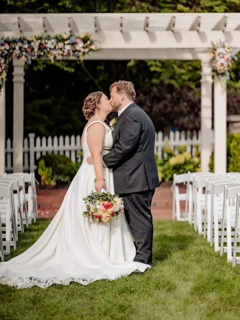 Newlyweds standing together in the Ambassador House garden