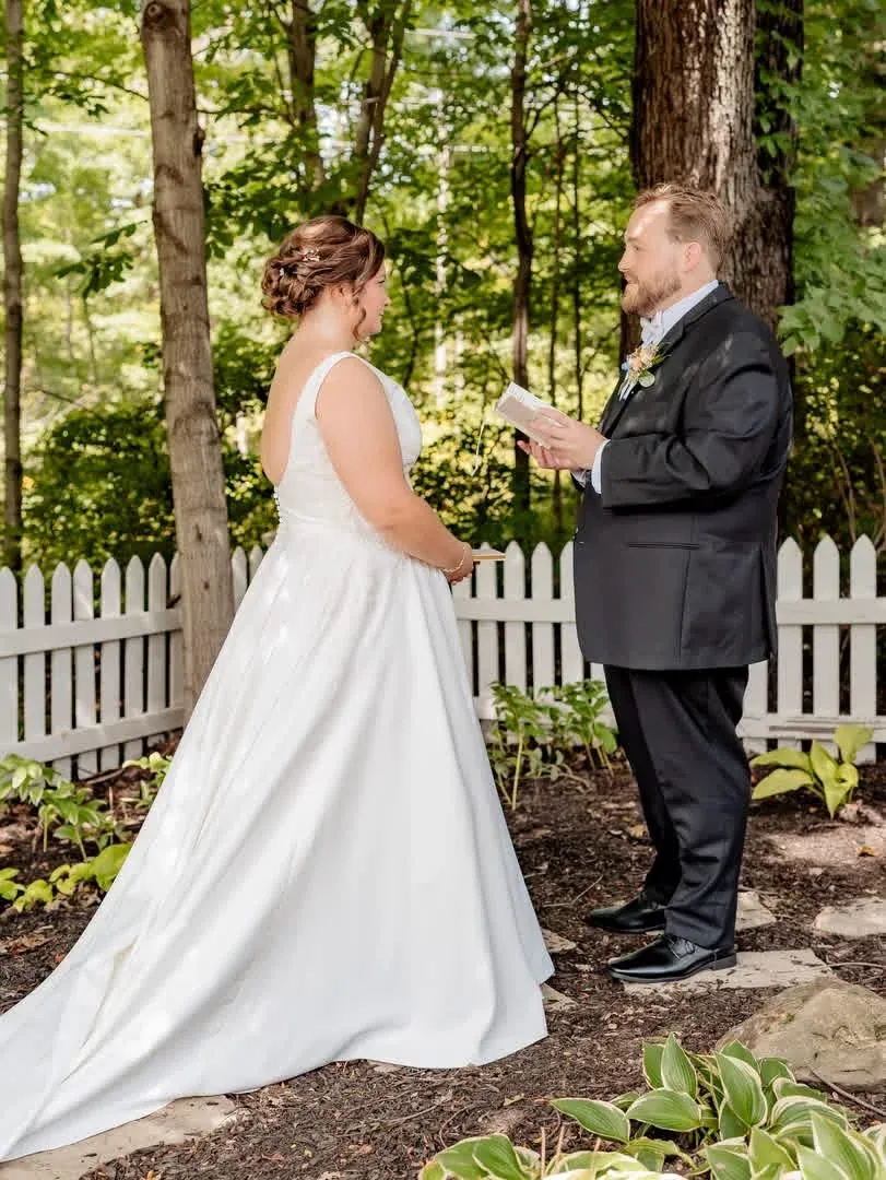 Newlyweds speaking together among the garden trees